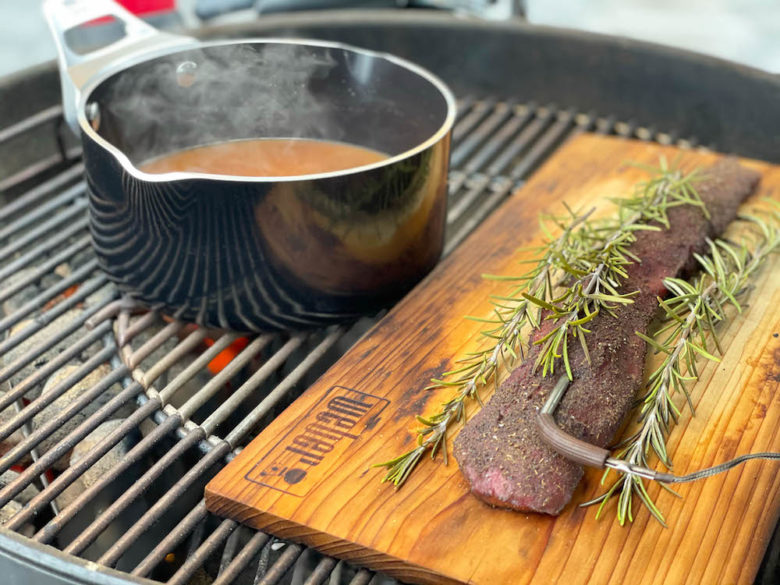 Zartrosa gegrillter Rehrücken auf Erbsenpüree - rehruecken erbsenpuerree 12 - 4 Rehrücken auf der Holzplanke mit einem Topf Wildfonds